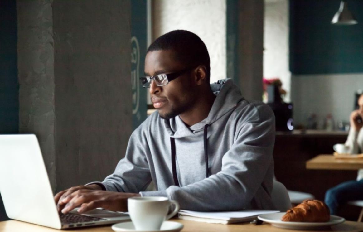 Business owner reviewing AI-generated financial insights on laptop